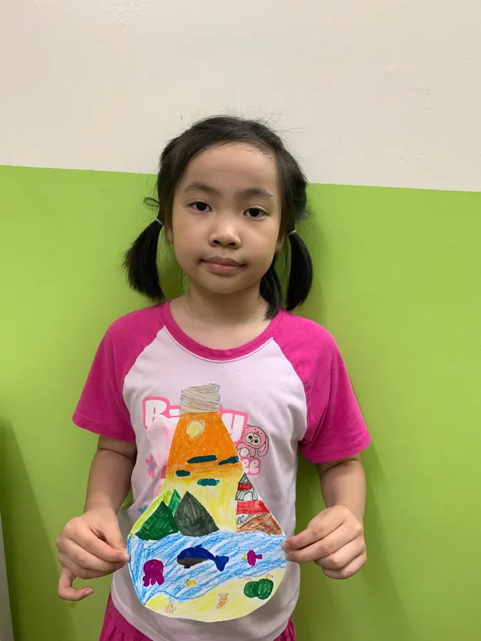 Student presenting her volcano art project