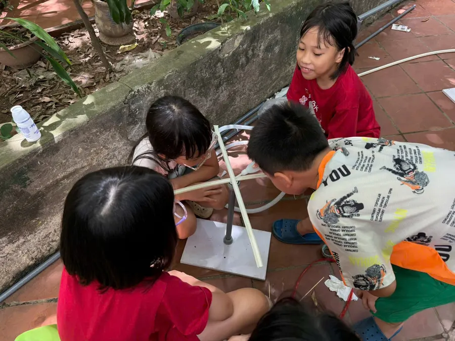 Students building a STEM project outdoors