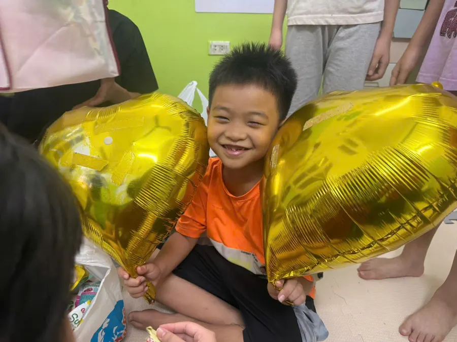 Happy student with balloons at a class celebration