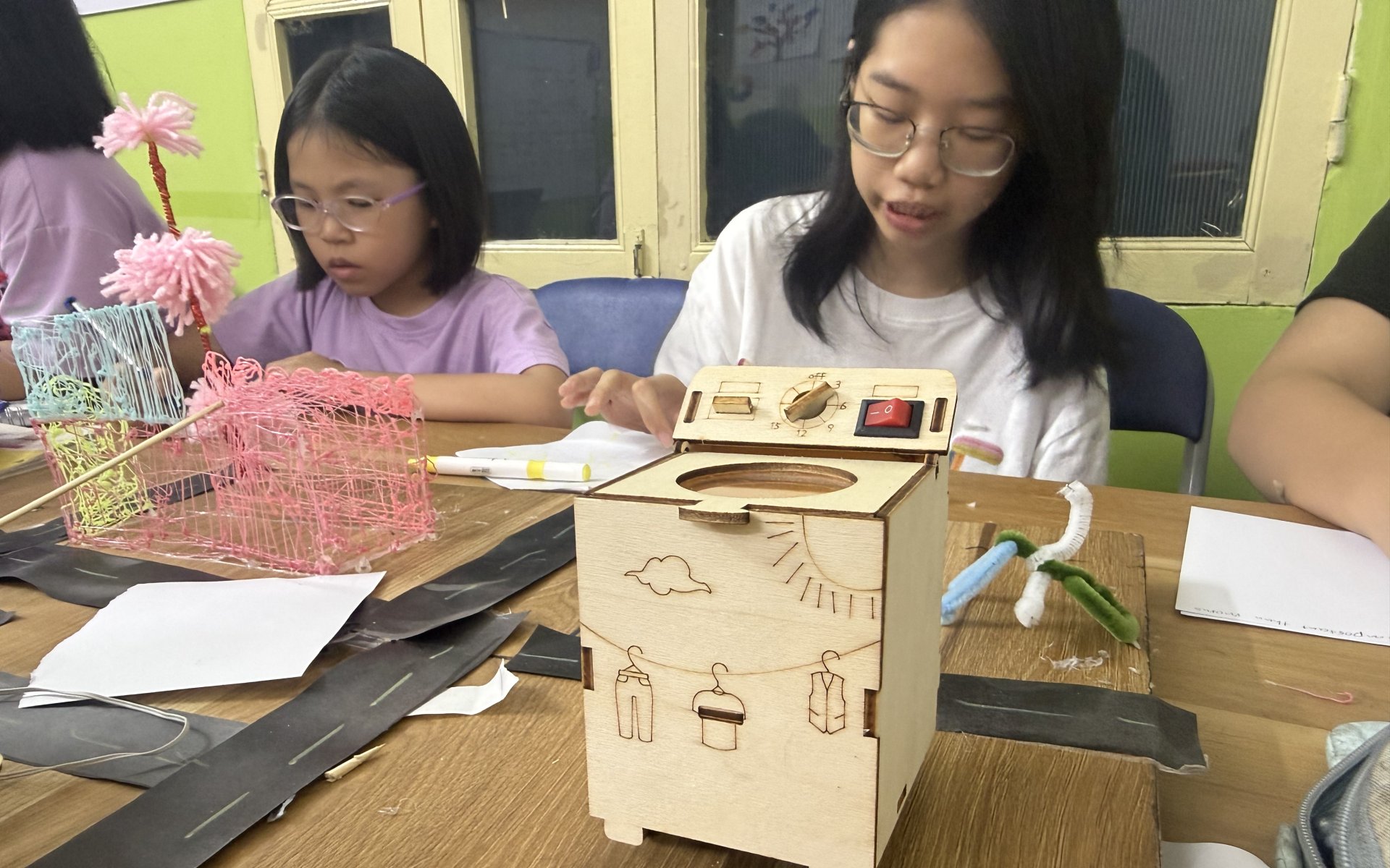 HEC student building a laser-cut engineering project